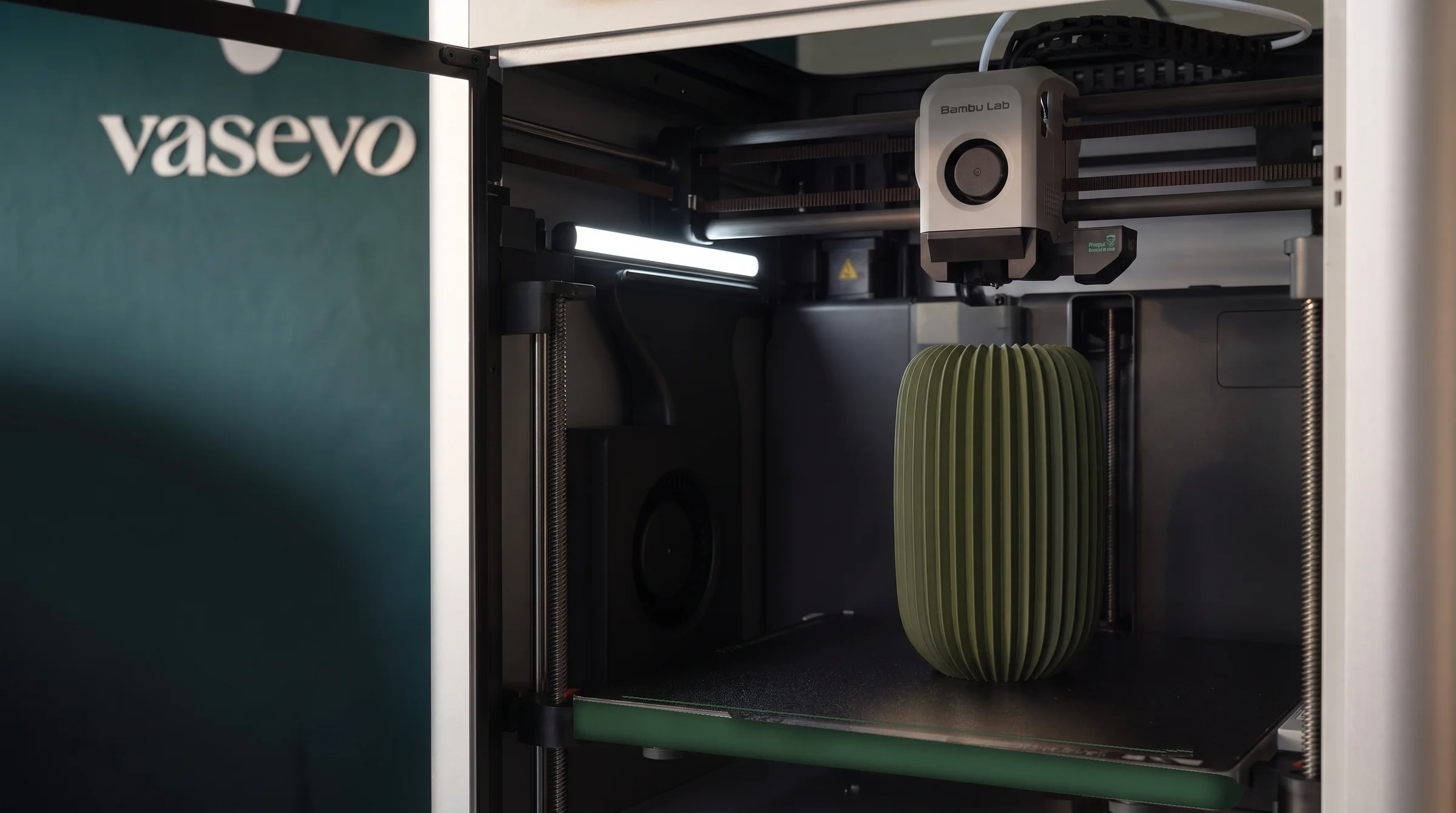 A studio printer with a finished Olivea vase in dark olive green